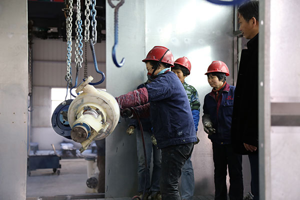 老師觀察公司員工進(jìn)行噴漆作業(yè)